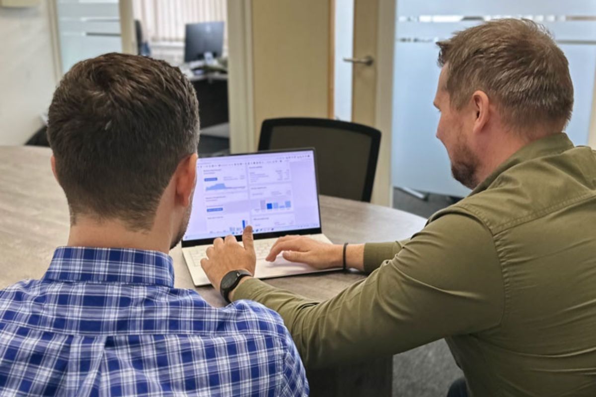 Two Lumin Accountancy employees looking looking at and typing on a laptop